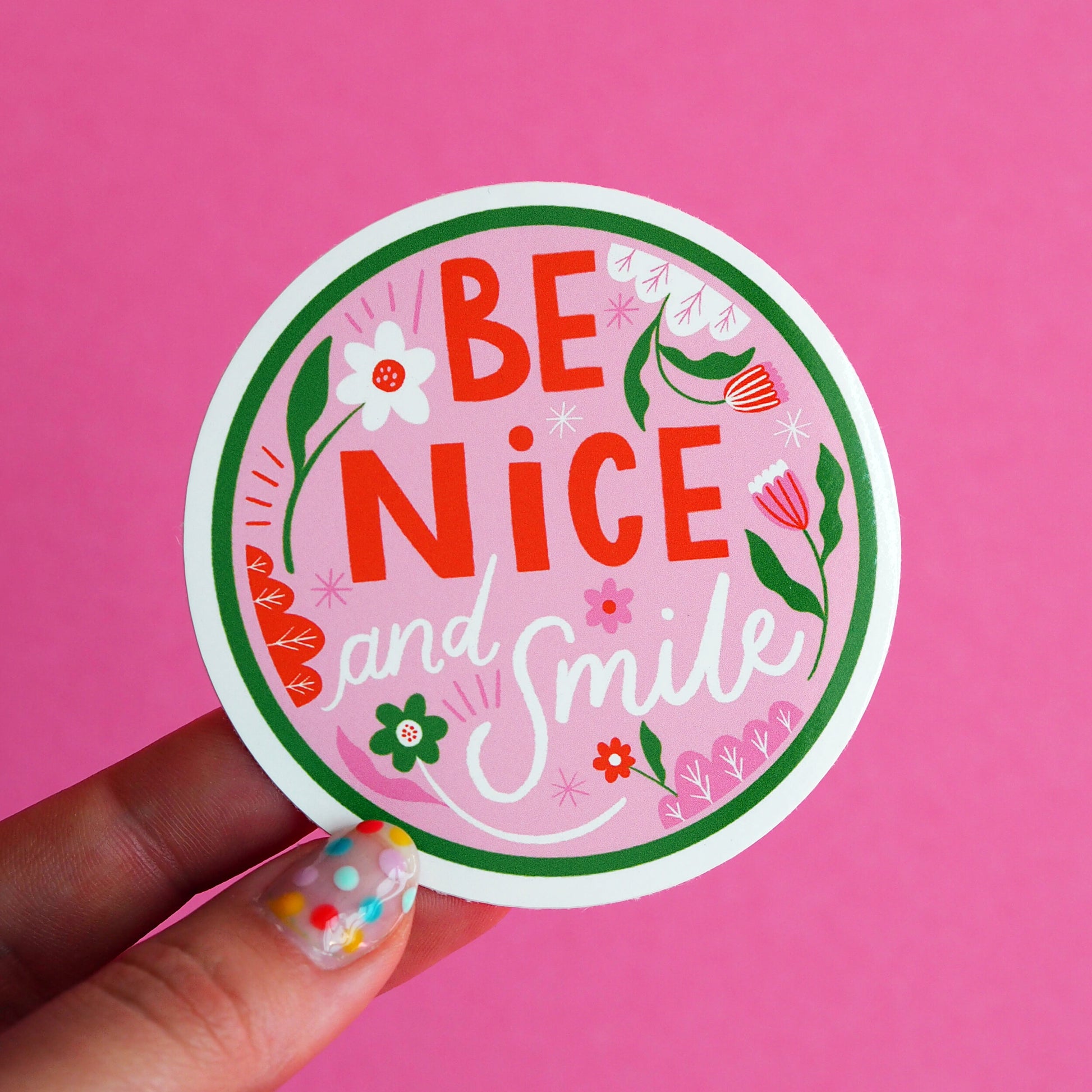 round vinyl sticker with text 'be nice and smile' pink and green florals