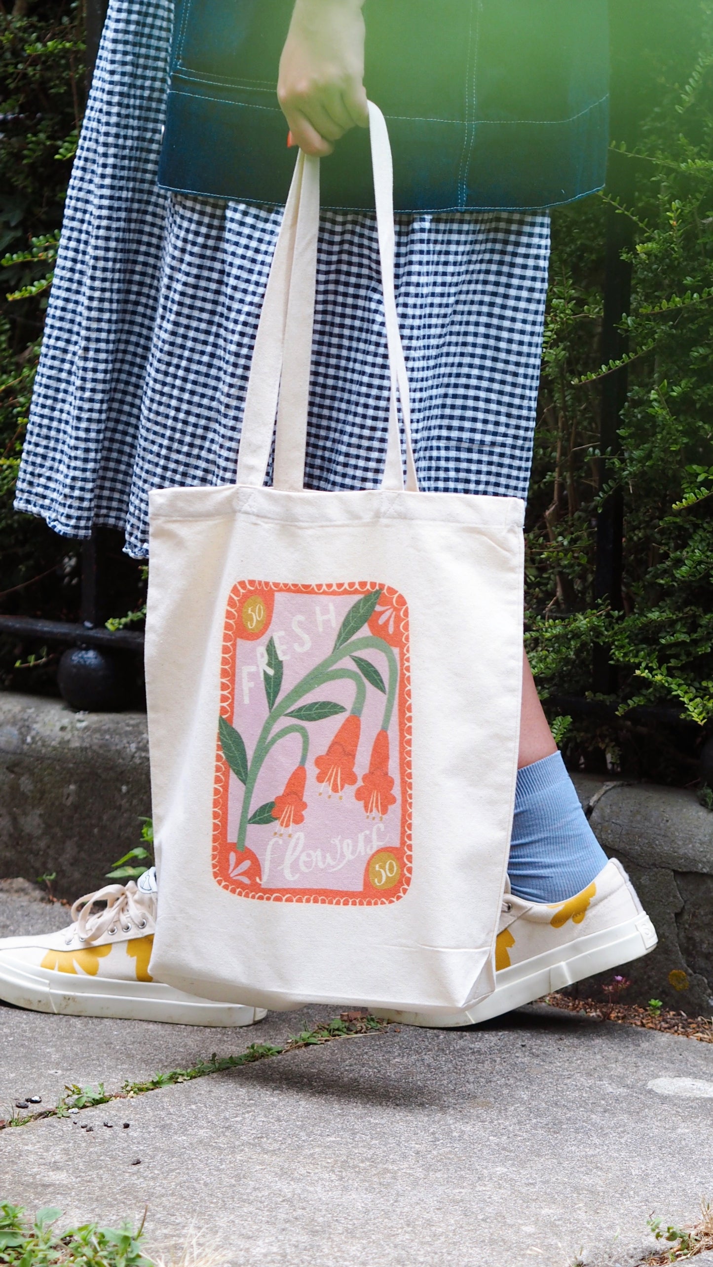 tote bag with red, lilac and green floral print. stamp design that says 'fresh flowers'
